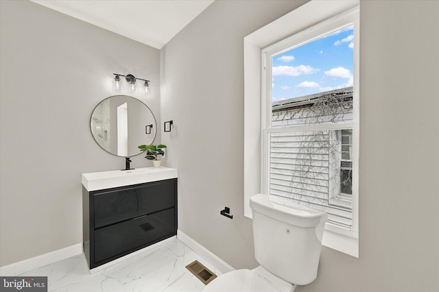 bathroom featuring vanity and toilet