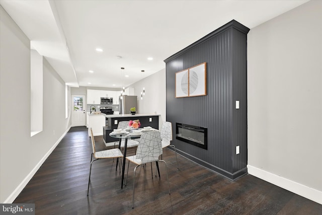 dining room featuring dark wood-type flooring and sink