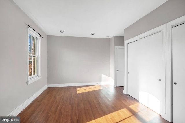 unfurnished bedroom with hardwood / wood-style floors