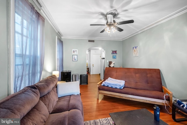 living room with hardwood / wood-style floors, ceiling fan, and ornamental molding