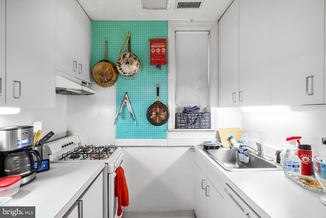 kitchen featuring sink, white cabinets, and white appliances