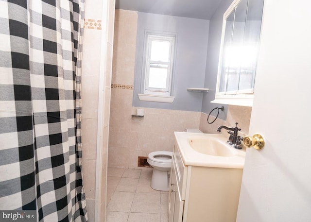 bathroom with tile patterned flooring, vanity, tile walls, and toilet