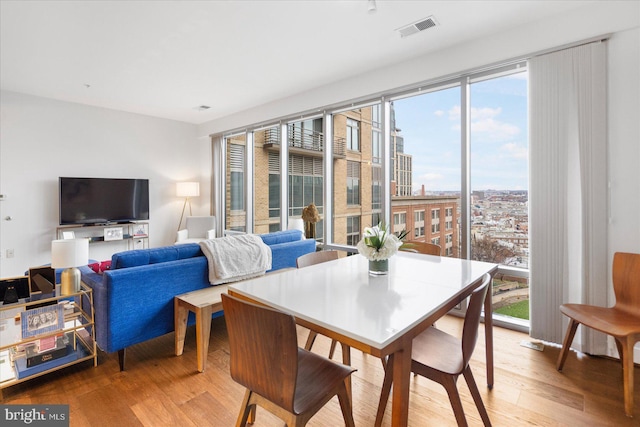 dining space with hardwood / wood-style floors