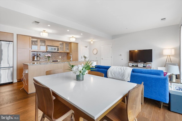 dining area featuring light hardwood / wood-style floors and sink