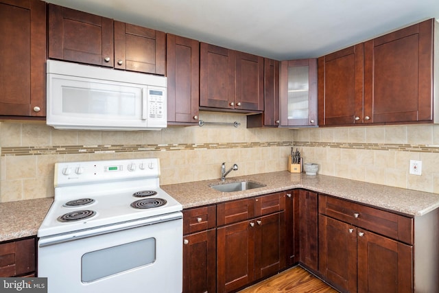 kitchen featuring decorative backsplash, sink, white appliances, and light wood-type flooring