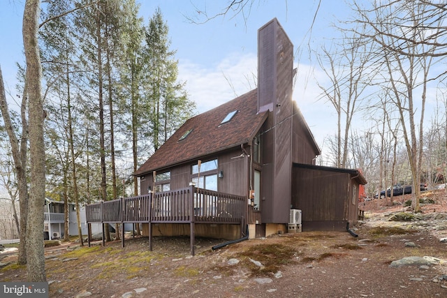 rear view of house featuring a deck