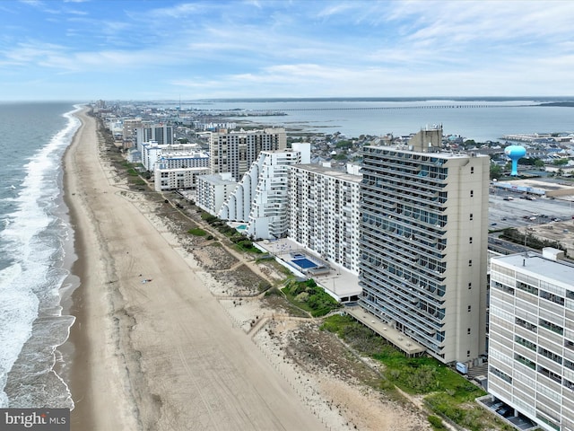 birds eye view of property featuring a view of the beach and a water view