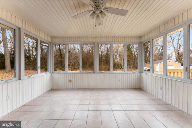 unfurnished sunroom with ceiling fan