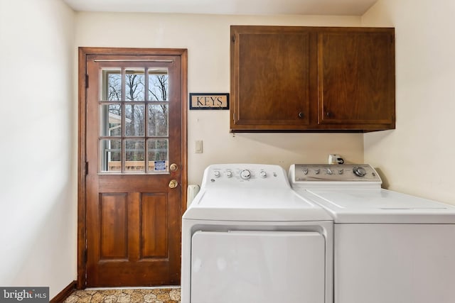 washroom with washing machine and dryer and cabinets