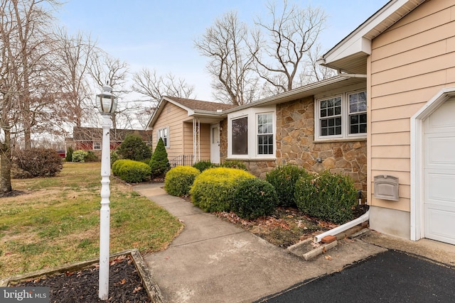 view of side of home with a lawn