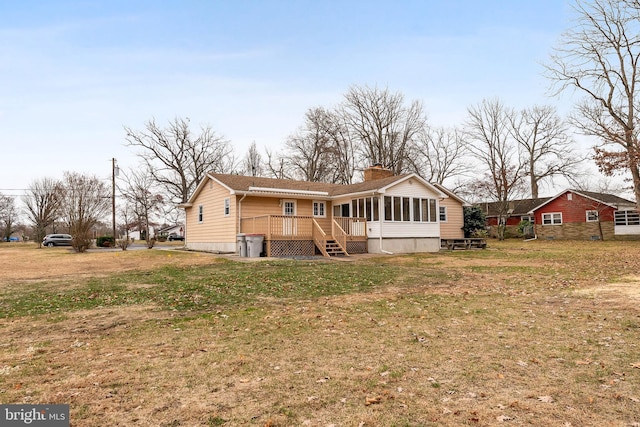 back of property featuring a yard