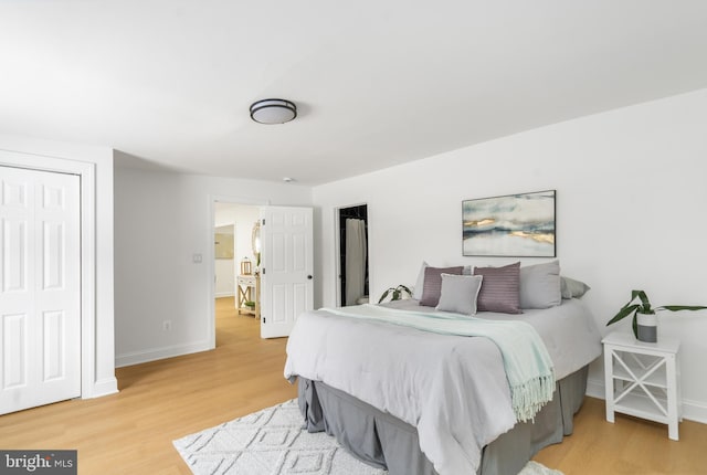 bedroom with a closet and hardwood / wood-style flooring