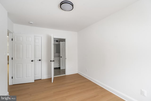 unfurnished bedroom with light wood-type flooring