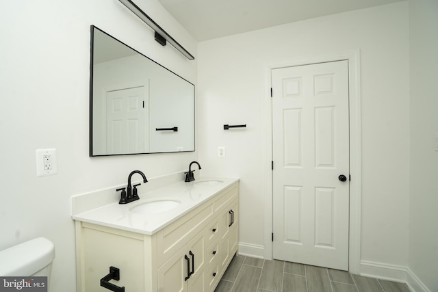 bathroom with toilet and vanity