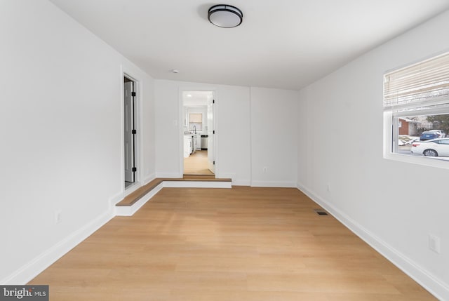 spare room featuring light wood-type flooring