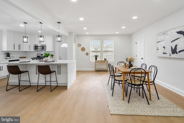 dining space with light wood-type flooring