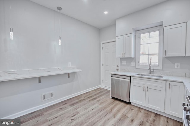 kitchen with dishwasher, light wood-type flooring, white cabinetry, and sink