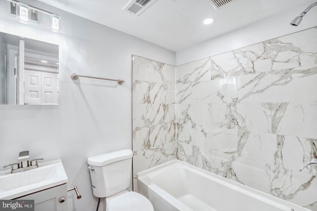 full bathroom featuring toilet, vanity, and tiled shower / bath