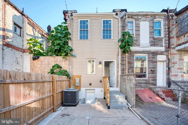 rear view of property featuring cooling unit