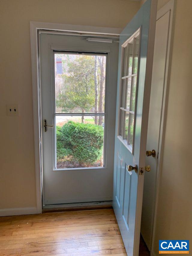 doorway with light wood-type flooring