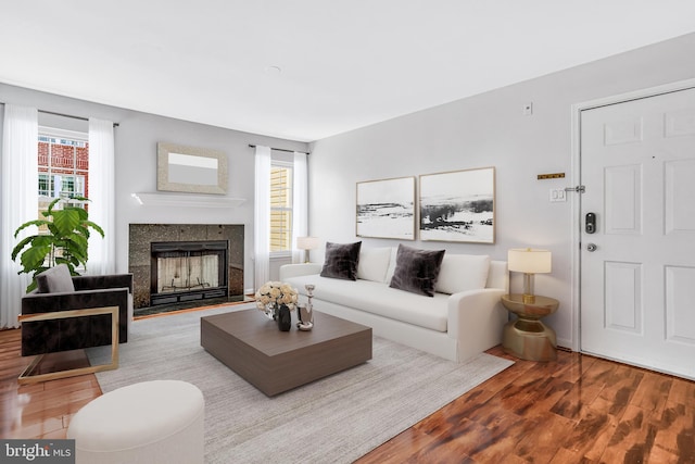 living room featuring hardwood / wood-style flooring, a fireplace, and a wealth of natural light