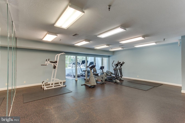 workout area with a textured ceiling