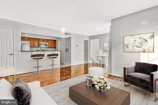 living room with light hardwood / wood-style flooring