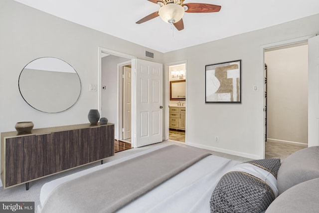 carpeted bedroom featuring ensuite bath and ceiling fan