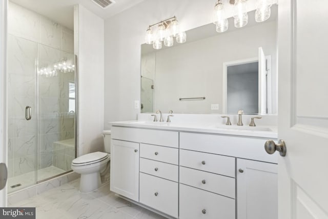 bathroom with vanity, toilet, and a shower with shower door