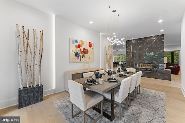 dining space featuring a notable chandelier and light hardwood / wood-style floors