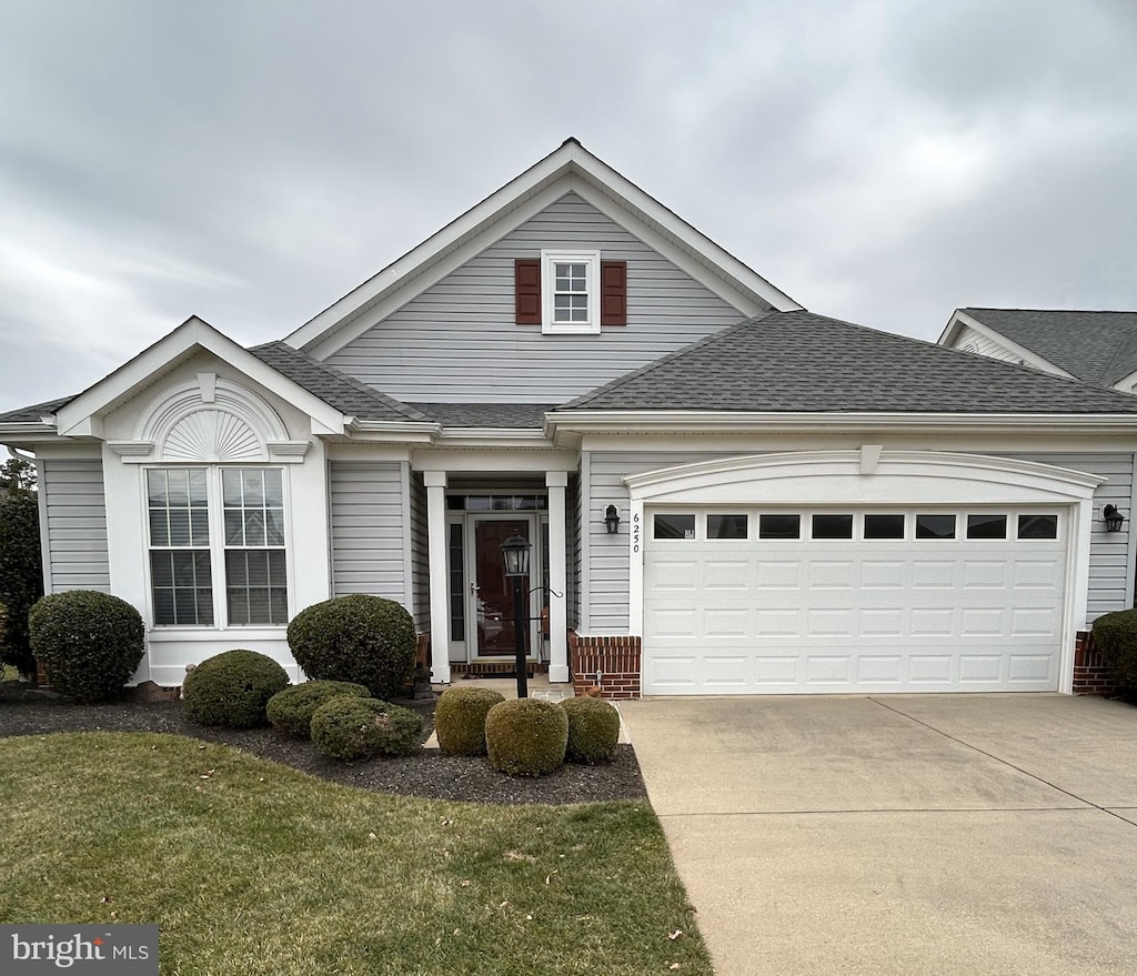 view of front of property featuring a garage and a front yard