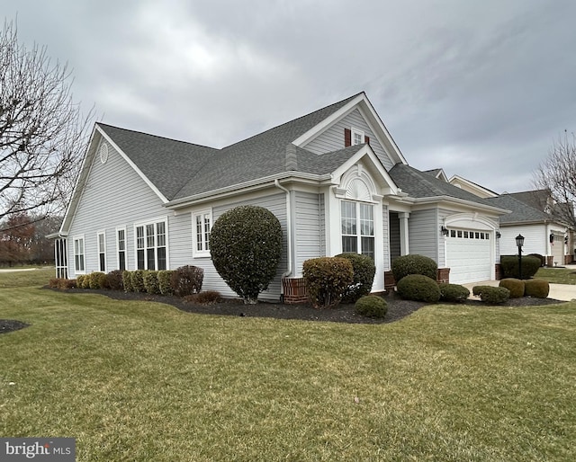 exterior space featuring a garage and a lawn