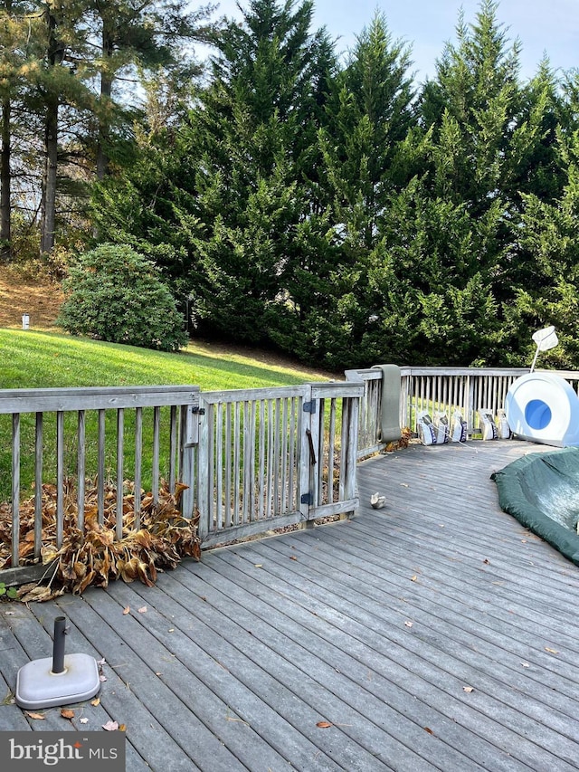 wooden deck featuring a yard