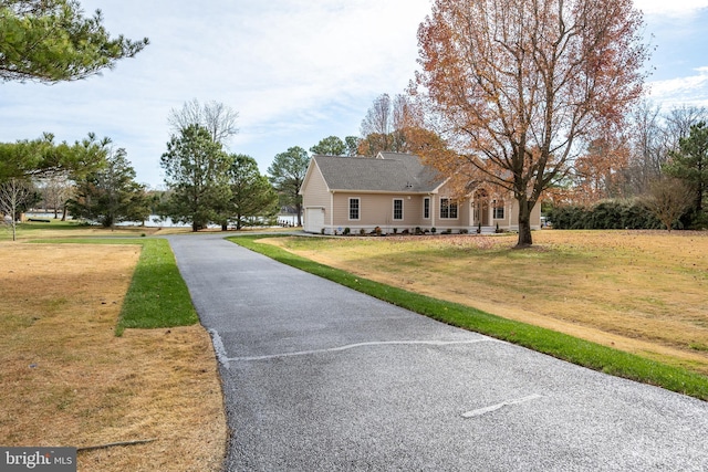 view of front of house featuring a front yard and a garage