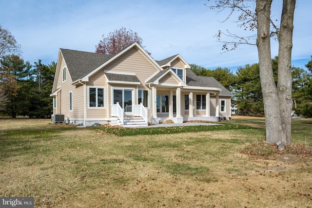 view of front facade featuring a front lawn, a porch, and cooling unit