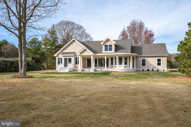 cape cod house with covered porch and a front yard