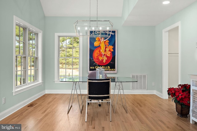 dining space featuring a chandelier and light hardwood / wood-style flooring