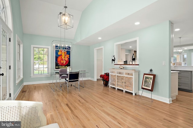 office with light hardwood / wood-style flooring and vaulted ceiling