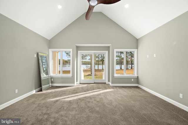 unfurnished living room featuring ceiling fan, carpet floors, and high vaulted ceiling