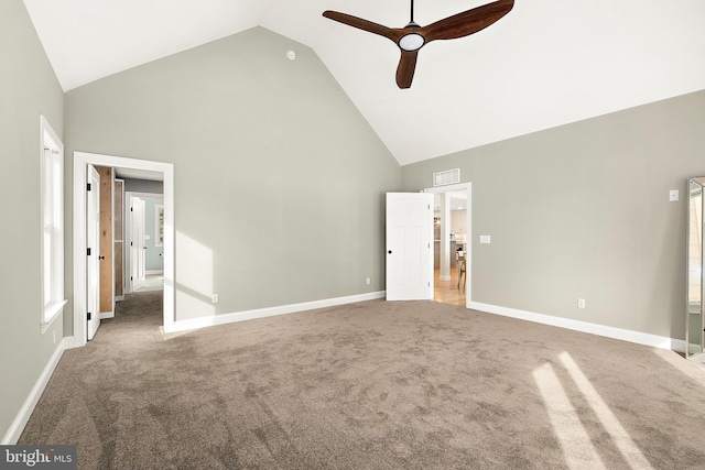 interior space with ceiling fan, carpet floors, and high vaulted ceiling