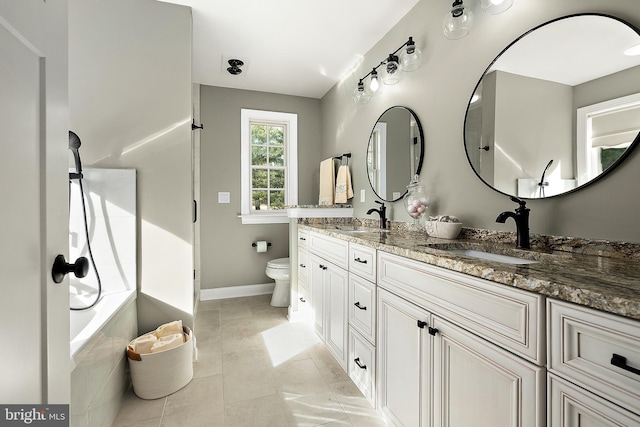 bathroom featuring tile patterned flooring, vanity, and toilet