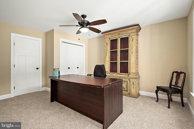 carpeted home office with ceiling fan