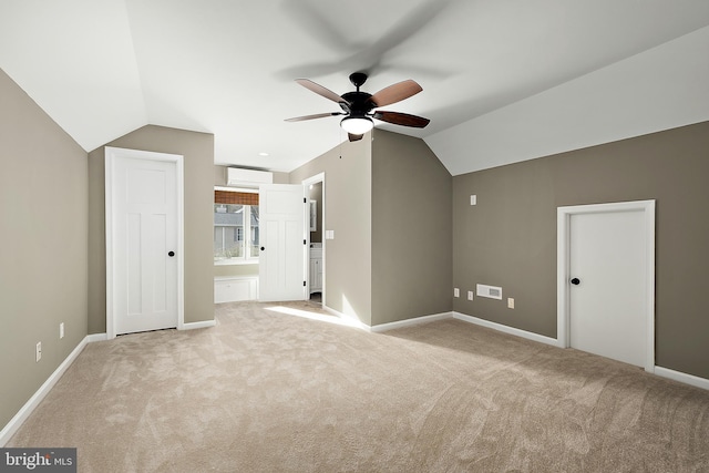 additional living space featuring light colored carpet, an AC wall unit, ceiling fan, and lofted ceiling