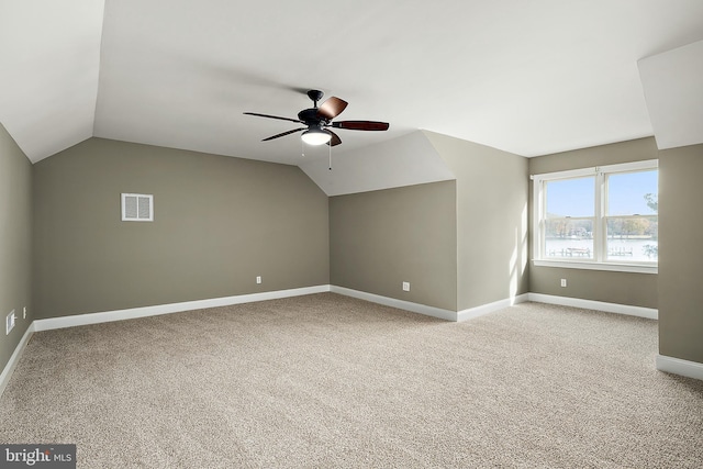 additional living space with carpet flooring, ceiling fan, and lofted ceiling