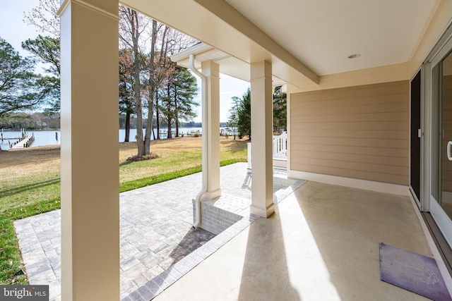 view of patio / terrace featuring covered porch and a water view