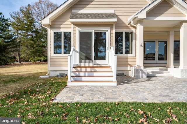 entrance to property with french doors and a yard