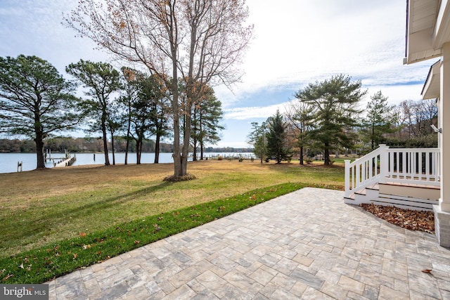 view of yard with a water view and a patio