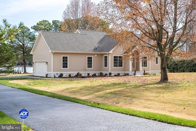 view of front facade with a garage and a front yard