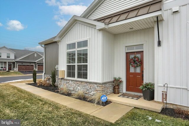 doorway to property with a lawn