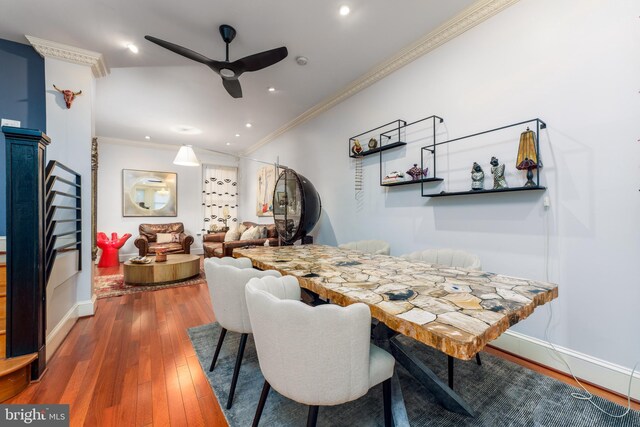 dining space with dark hardwood / wood-style floors, ceiling fan, and crown molding